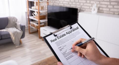 appraiser writing on a document titled real estate appraisal peoria il