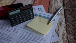 document on a table with a note and calculator peoria il